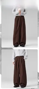 Front detail of men's high-waisted cotton wide-leg trousers in dark brown color