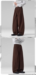 Detailed view of brown wide-leg trousers featuring elastic waist and high-quality cotton fabric