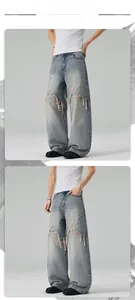 Close-up of distressed light blue denim jeans with large ripped details and raw edges