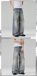 Detail of distressed wide-leg jeans featuring heavy washing and frayed hole design
