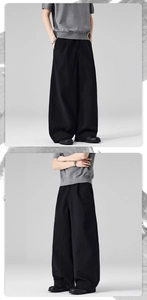 Detail of men's black wide-leg trousers in premium twill cotton with a loose fit silhouette