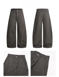 Macro detail of dark grey wide-leg cargo pants showing metal buttons and pockets