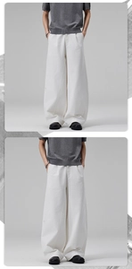 Detailed view of men's white wide-leg trousers in premium cotton with a loose fit