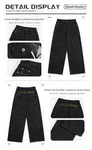 Detail view of baggy washed denim jeans featuring yellow embroidered pockets and high waist
