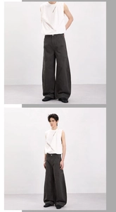 Detail view of charcoal wide-leg cargo pants paired with a white cutout sleeveless top