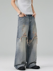 Men's retro distressed wide leg denim jeans with ripped details and a light blue wash