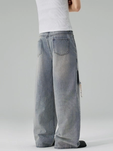 Light blue wide leg distressed jeans with raw hem and vintage wash for men street style