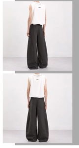 Detail view of the back branding print on a white vest and baggy cargo pants outfit