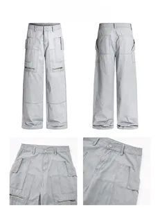 Detail view of light grey wide-leg cargo pants featuring multi-pockets and metal zippers