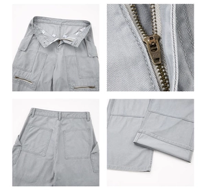 Detail view of grey work trousers showing YKK zipper, buttons, and stitching on twill cotton