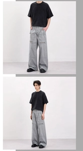 Detail of vintage gray cargo pants with wide-leg cut and relaxed black cotton T-shirt