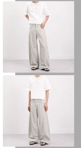 Détail du pantalon cargo beige clair avec coutures incurvées et coupe plissée 3D