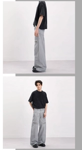 Detailed side view of loose-fit vintage grey cargo pants featuring functional zipper pockets