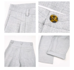 Detailed views of light gray trousers showing amber button, pockets and textured fabric