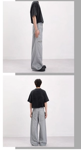 Detail view of oversized vintage work pants with metal zipper and large utility pockets