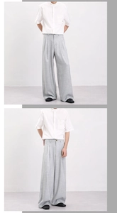 Detailed view of gray wide-leg trousers with bamboo texture and elegant drape for men