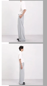Detail of light gray wide-leg trousers with micro-texture and high-waist drape