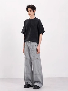 Vintage washed black t-shirt and grey wide-leg cargo pants with metallic zipper details