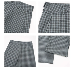Detail view of gray plaid pants showing waistband, side pockets and fine fabric texture