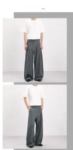 Close-up showing the vintage gray plaid texture and wide-leg cut of these retro trousers