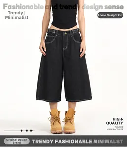 Detail view of loose straight fit black denim carpenter shorts with utility waist buckle