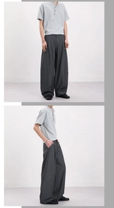 Detail of vintage striped wide-leg pants and grey polo shirt for men's casual outfit