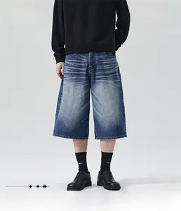 Close-up of loose straight fit denim shorts with vintage cat whisker washing effect