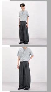 Close-up detail of retro striped wide-leg trousers and casual short sleeve henley top