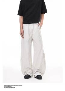 Close-up of lightweight pleated cargo pants with drawstring waist and wide leg cut