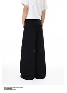 Rear view of black cargo pants showing wide-leg fit and large flap pockets on a model