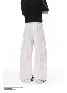 Rear view of light gray wide-leg cargo pants showing pleated details and elastic waist