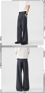 Detail of dark grey wide-leg trousers with front pleats and a high-waisted straight cut