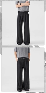 Close-up of pleated high-waisted black trousers with a sleek belt and draped fabric