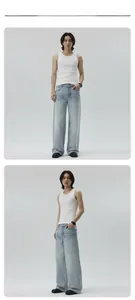 Detail view of men's white ribbed tank top and light blue wide-leg washed denim jeans