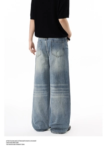 Close-up of baggy wide-leg jeans back view with vintage washed blue denim texture