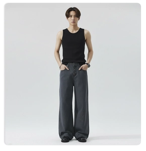 Detail of dark grey wide-leg denim jeans with vintage multi-button closure and ribbed vest