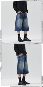 Detail view of baggy distressed denim shorts showing stone washed finish and cat whiskers effect
