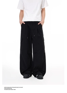 Detail view of black cargo pants with side pockets and adjustable drawstring waist