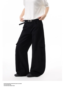 Detail of black multi-pocket cargo pants featuring heavy cotton twill and metal buckle belt