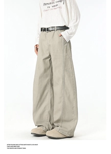 Detail of light khaki cargo trousers with a black belt and vintage stitching accents