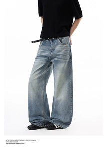 Detail of vintage washed blue wide-leg denim jeans with cleanfit high street aesthetic