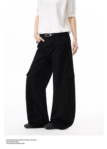Detail view of black high-waisted cargo pants featuring wide legs and utility side pockets