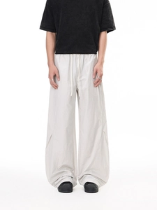 Men's loose vintage cargo pants in off-white with drawstring waist and wrinkled fabric