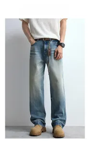 Detail of light blue straight-leg jeans featuring vintage whiskers and faded wash process
