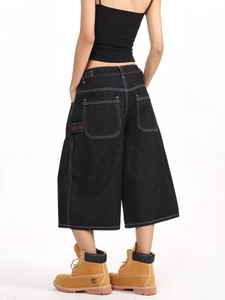 High street black denim carpenter shorts with white contrast stitching and pink embroidery