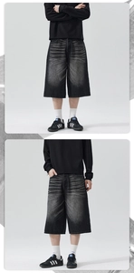 Close-up of heavy-wash denim shorts featuring hand-drawn whiskering and a wide-leg silhouette