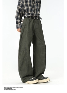 Detail of dark olive green wide-leg cargo pants featuring contrast stitching and loose fit