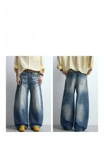 Front and back views of retro washed wide-leg denim jeans with cat-whisker detailing