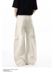Back view of cream wide-leg cargo pants for men with large side flap pockets and a relaxed fit