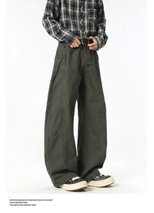 Detail view of olive green cargo pants showing high-quality stitching and cotton fabric texture